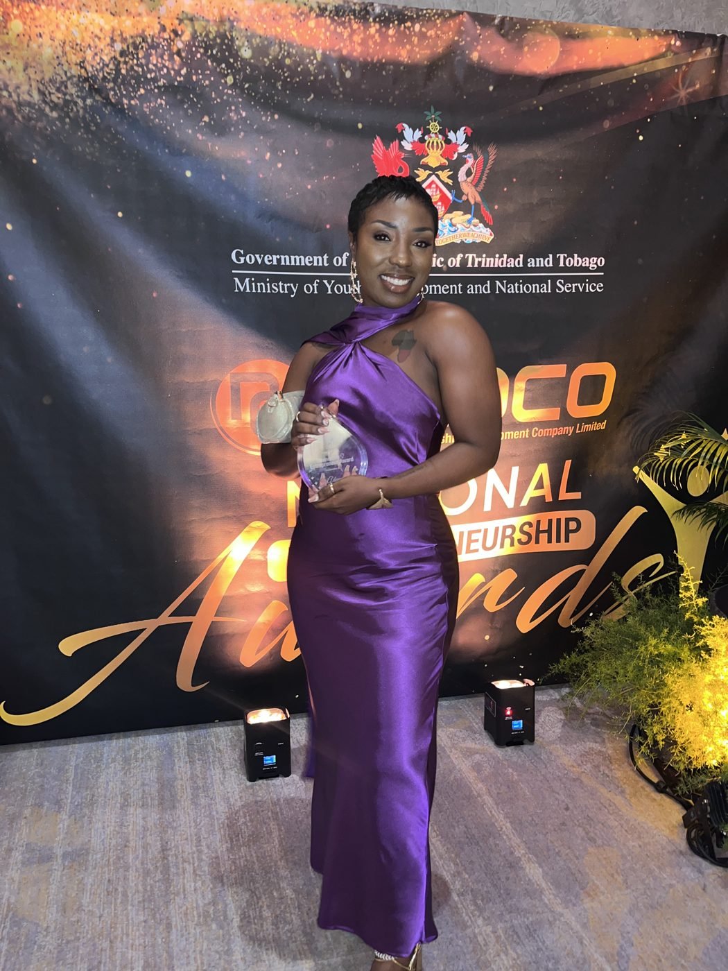 Adanna Taylor, founder of Taylor M Academy, holding the NEDCO Innovative Entrepreneur Award at the 2023 National Entrepreneurship Awards in Trinidad and Tobago